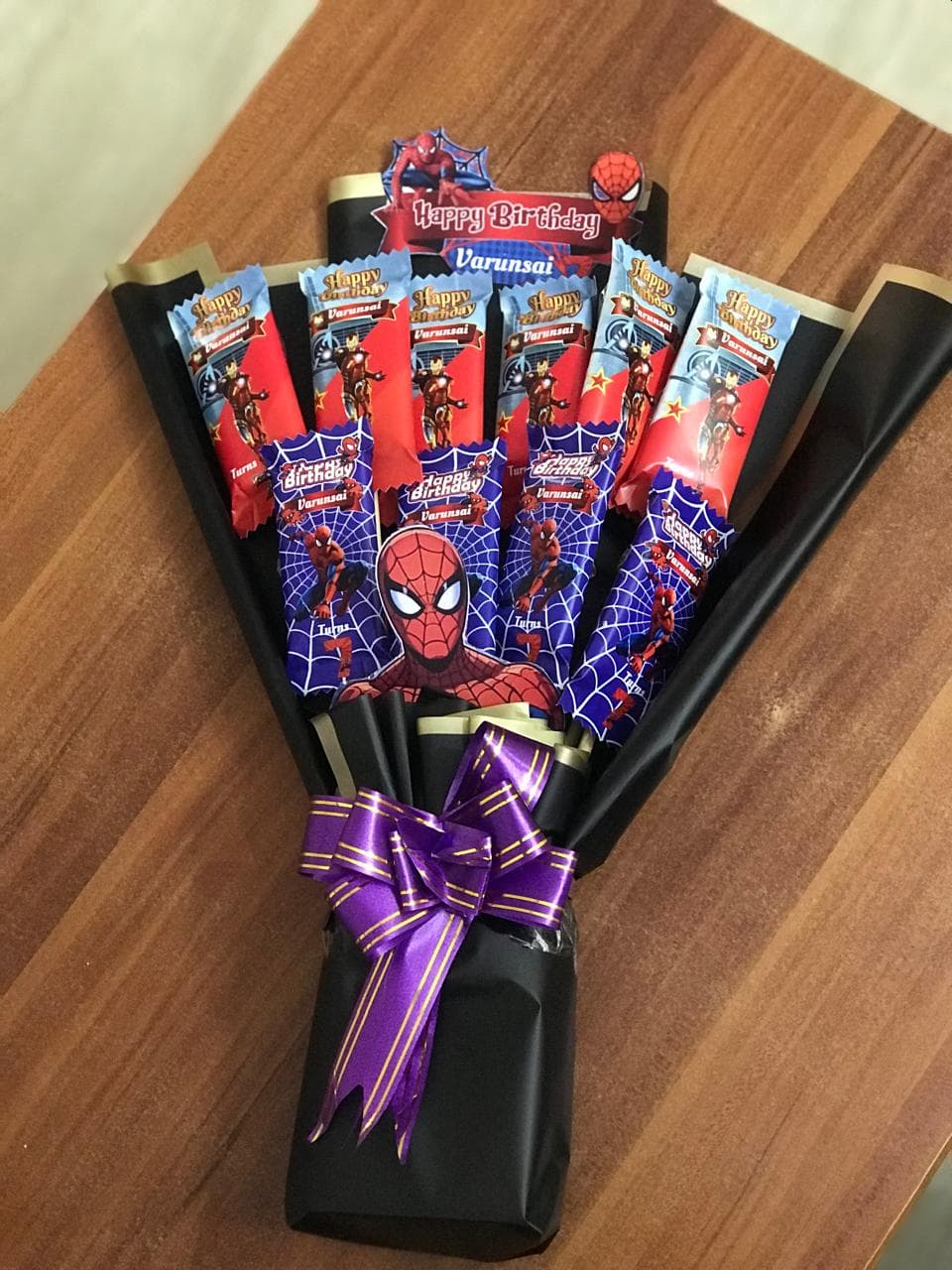Spider-Man and Iron Man superhero chocolate bouquet wrapped in black with a purple bow.