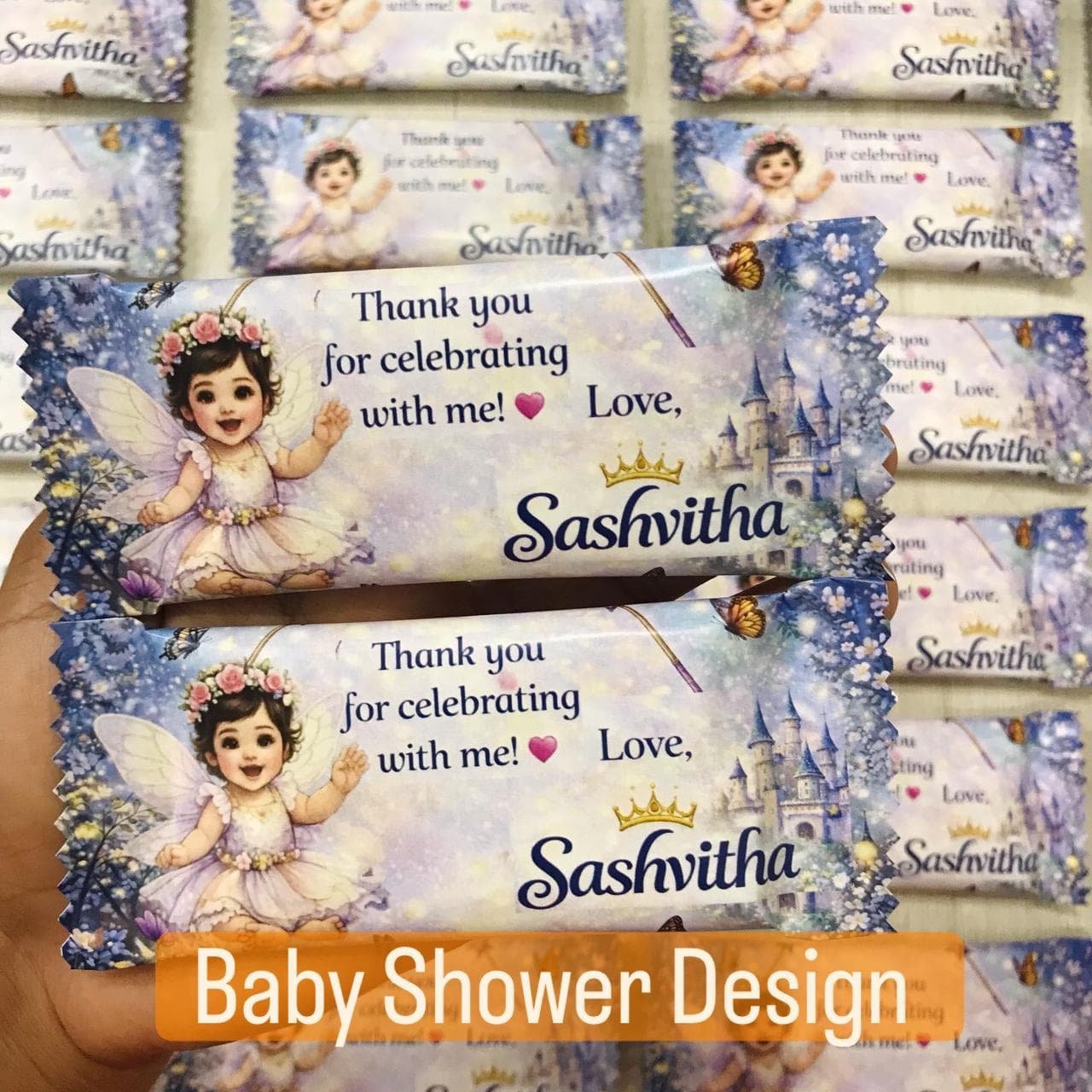 Fairy-themed baby shower chocolate wrappers featuring a baby fairy, castle, and personalized thank you message.